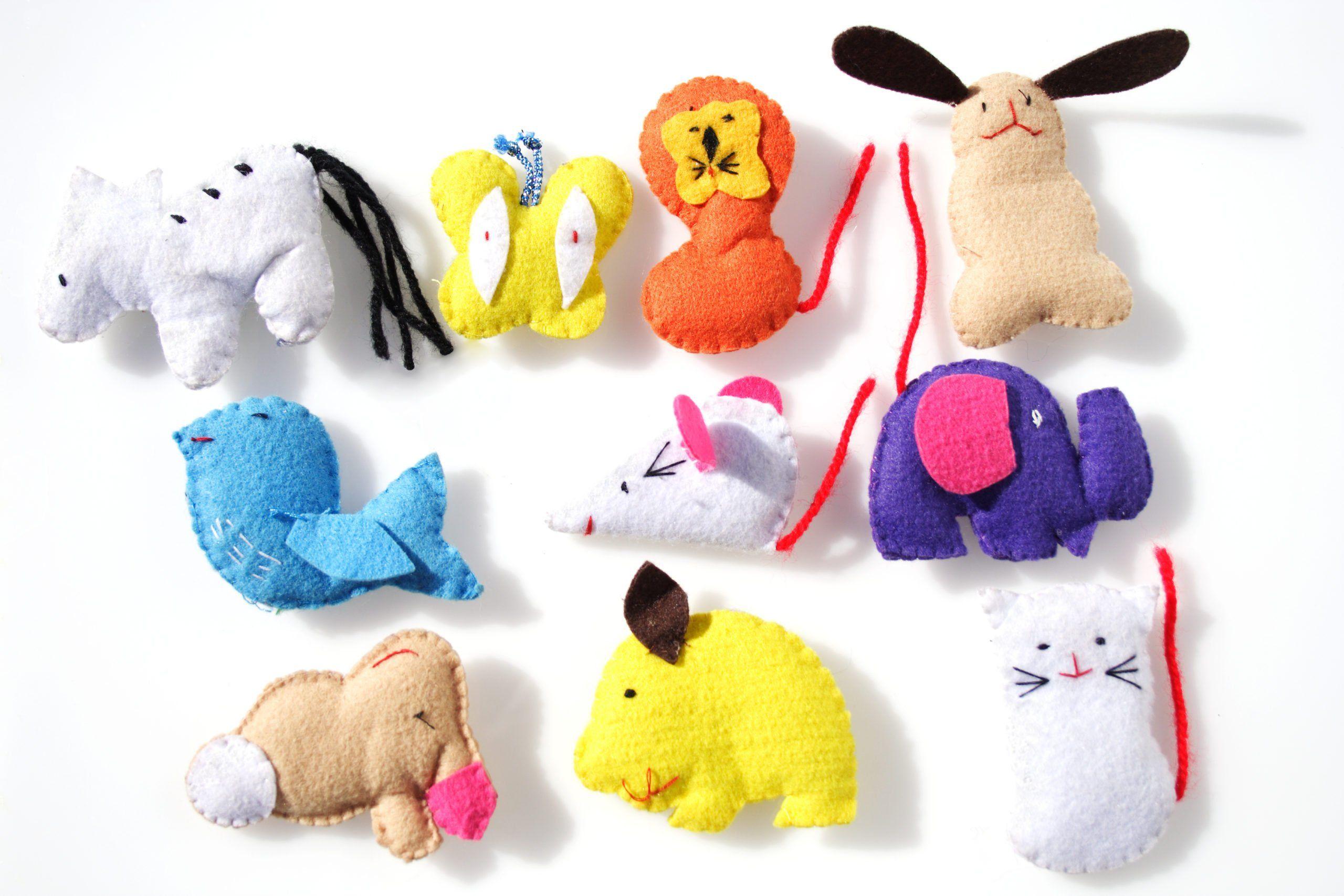 A range of stuffed felt toys made by children.