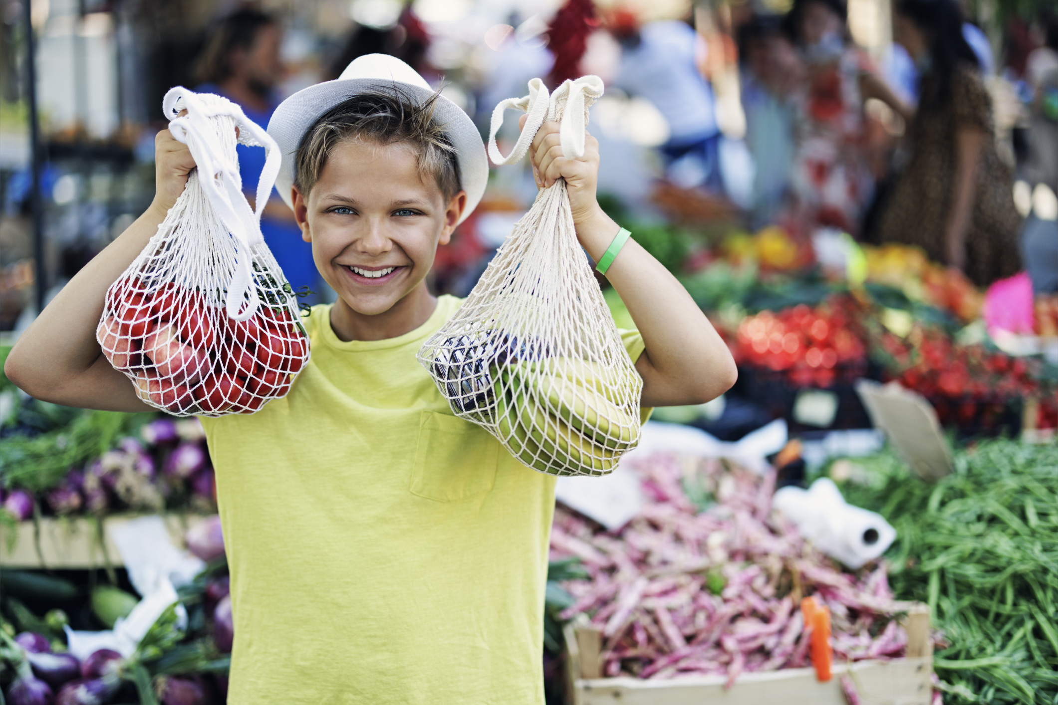 Teenage boy buying groceries at the farmer's market