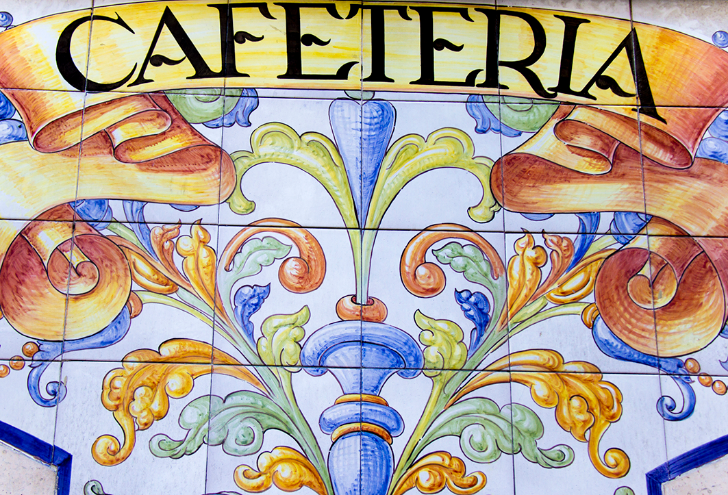 Colourful ceramic tiles spelling "CAFETERIA" with decorative designs.