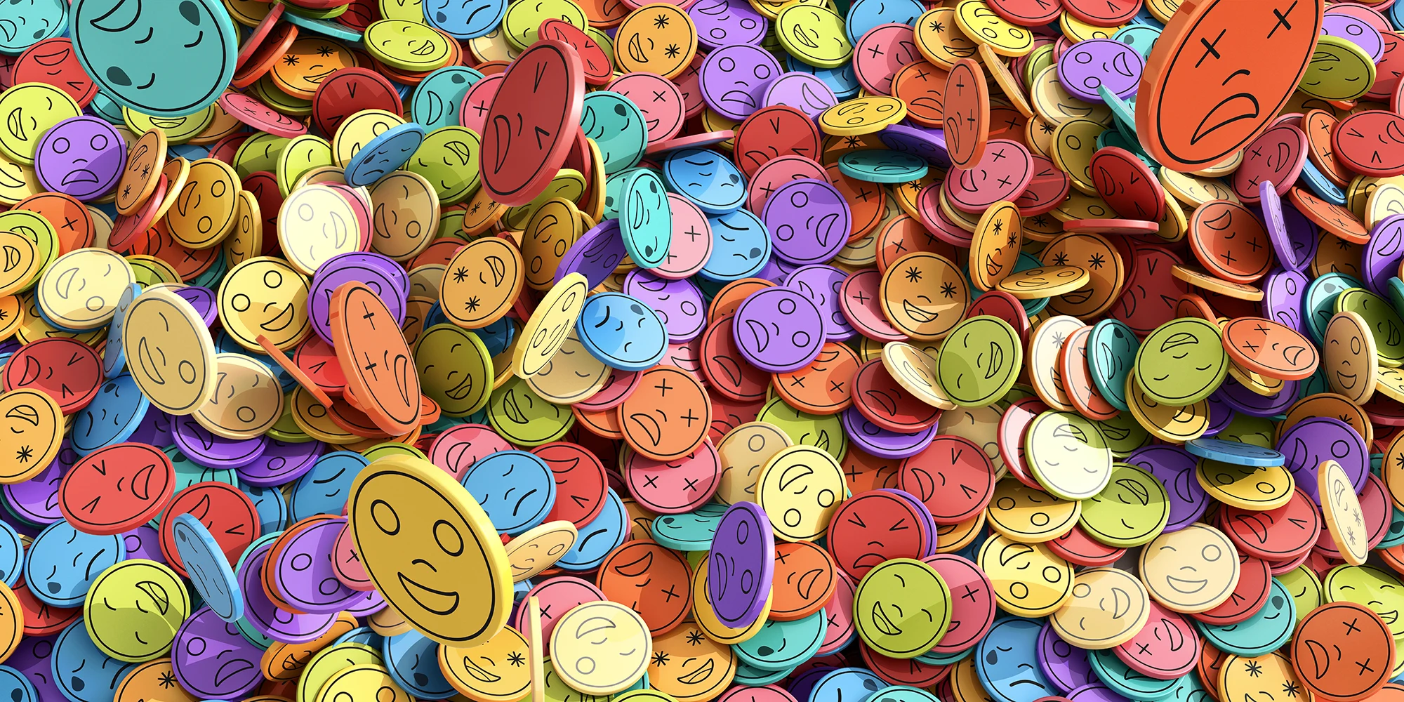 A large collection of colourful tokens showing different facial expressions, representing a wide range of emotions and feelings.