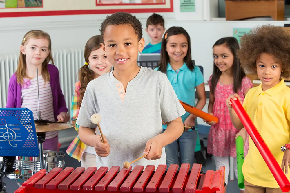 School children play selection of musical instruments