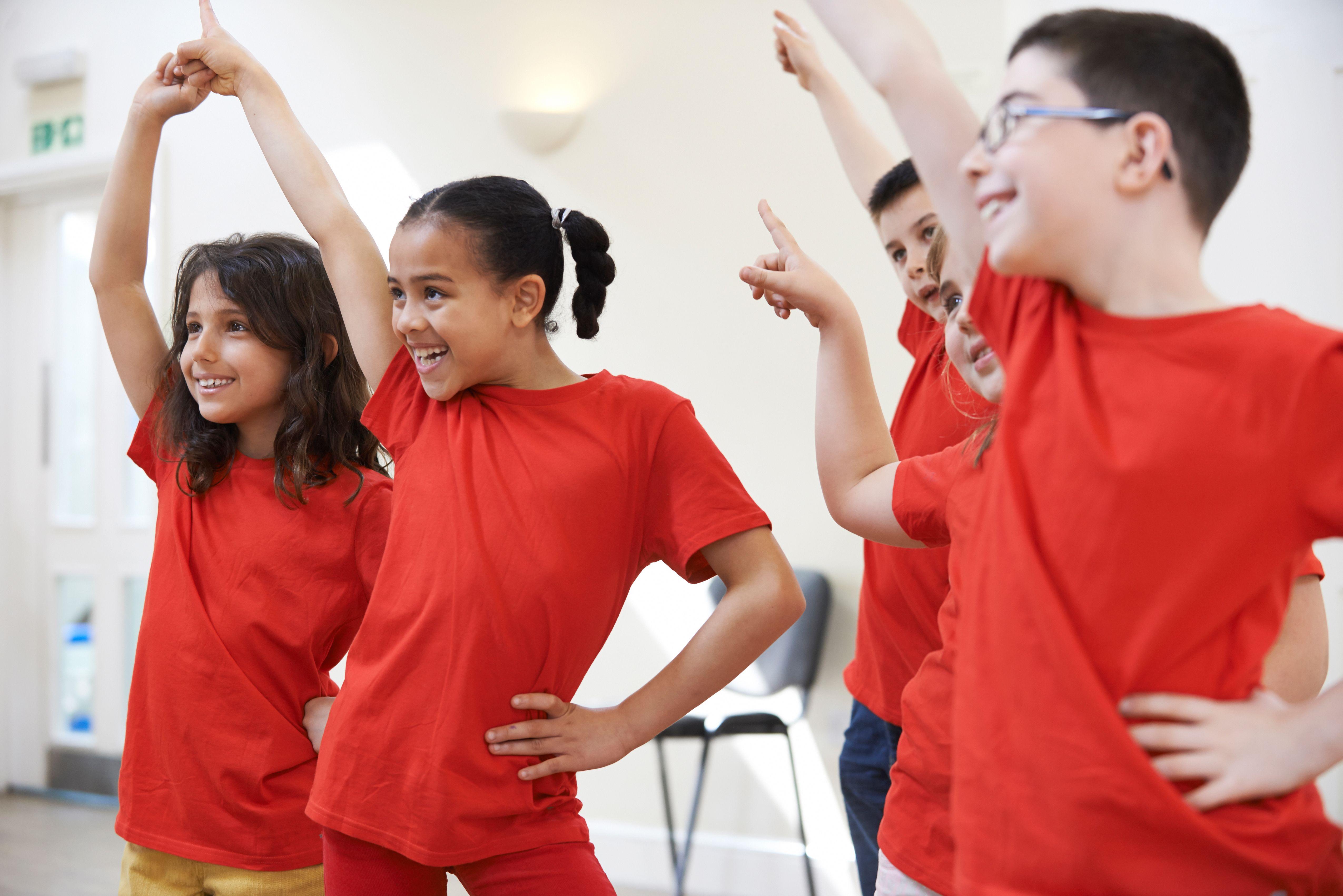 children in PE kit dancing