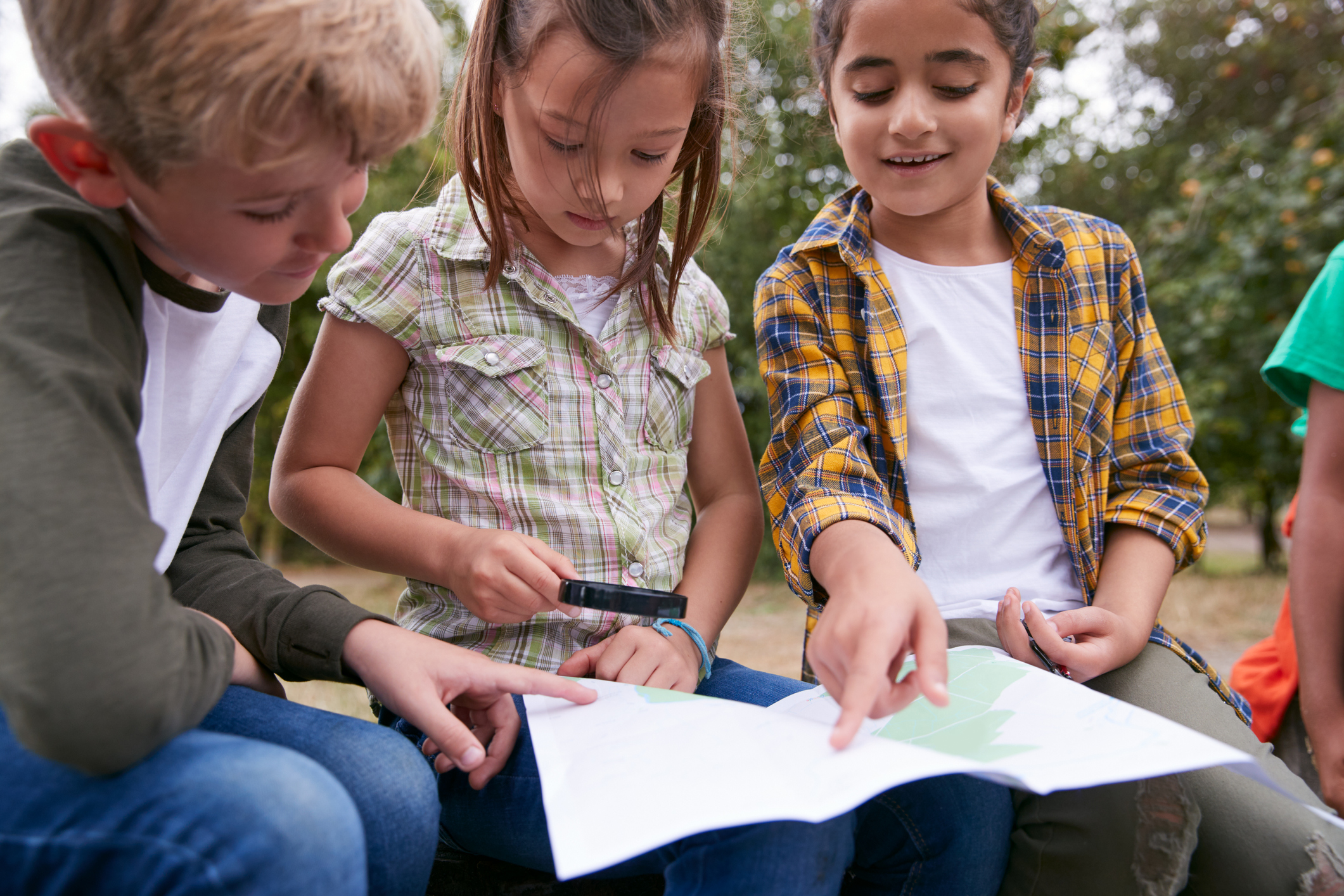 Three children looking at a map.