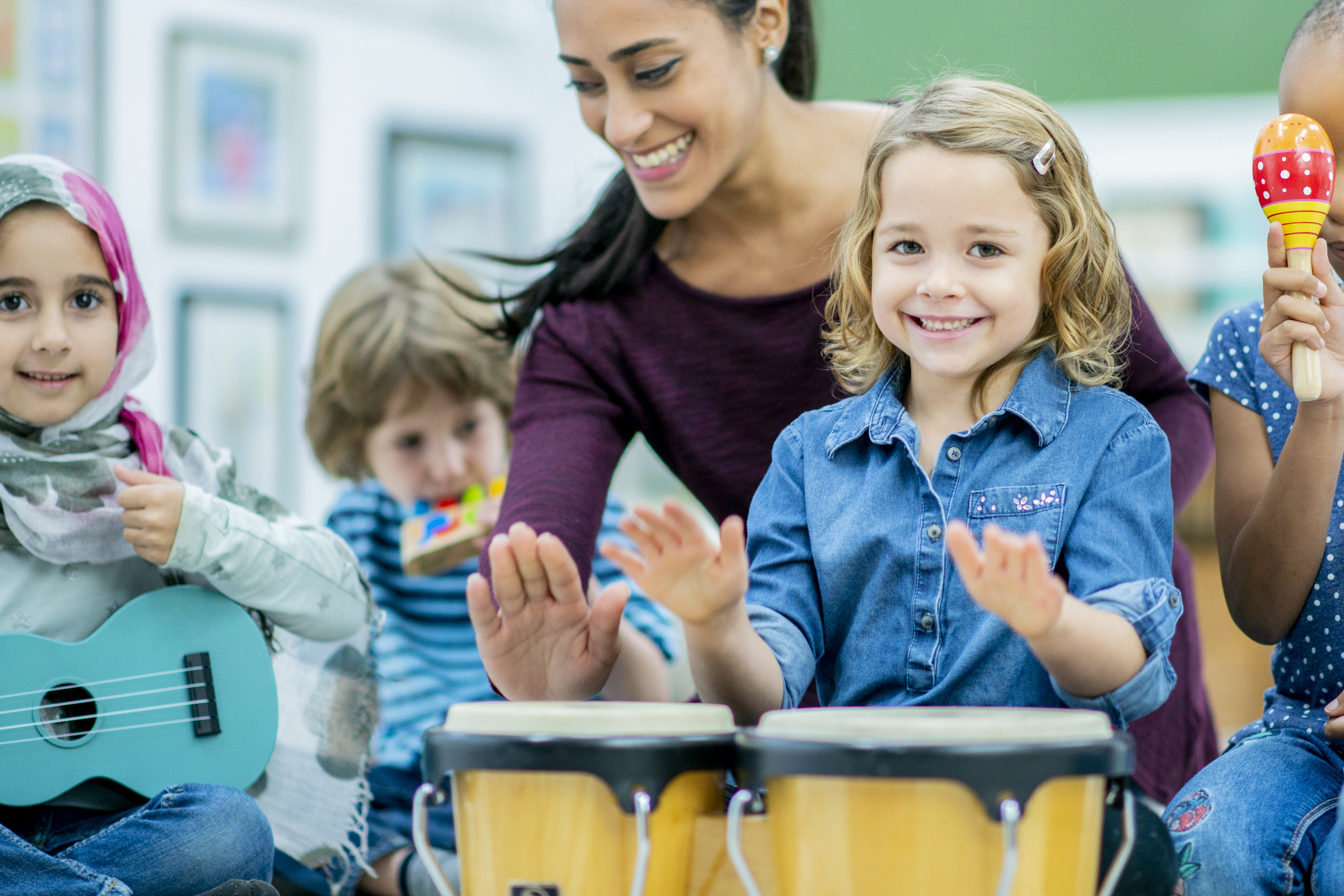 A teacher and pupils playing musical instruments