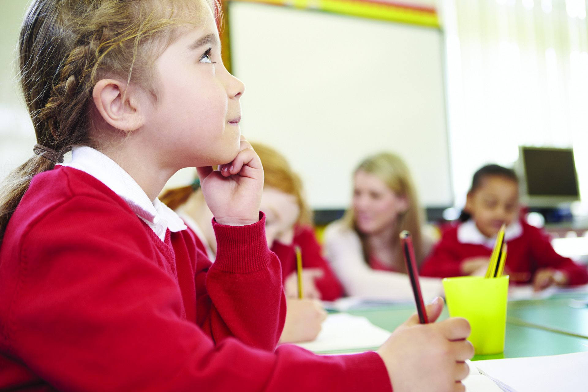 Child thinking with their hand on their chin