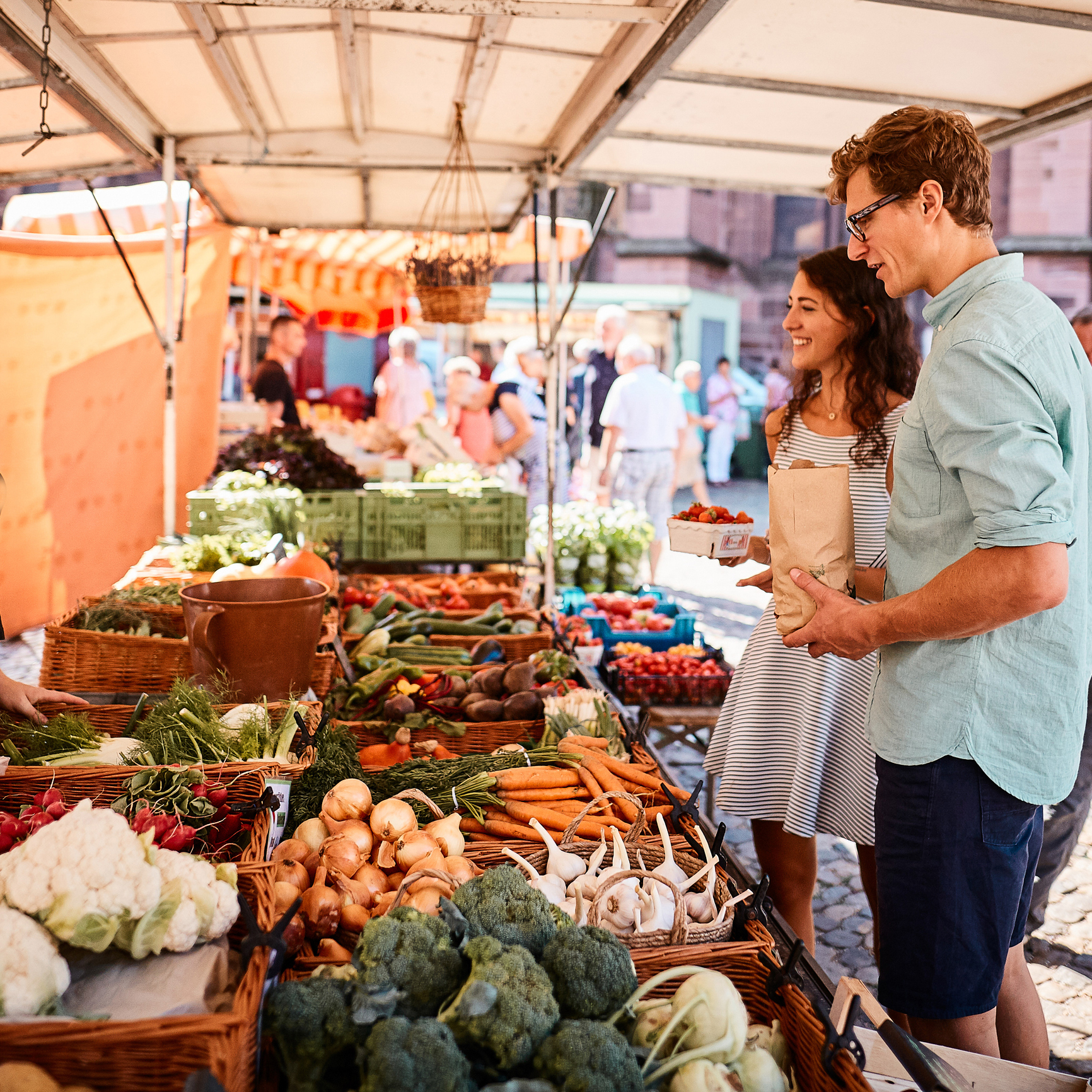Two people shopping at outdoor fruit market iStock 1147569801