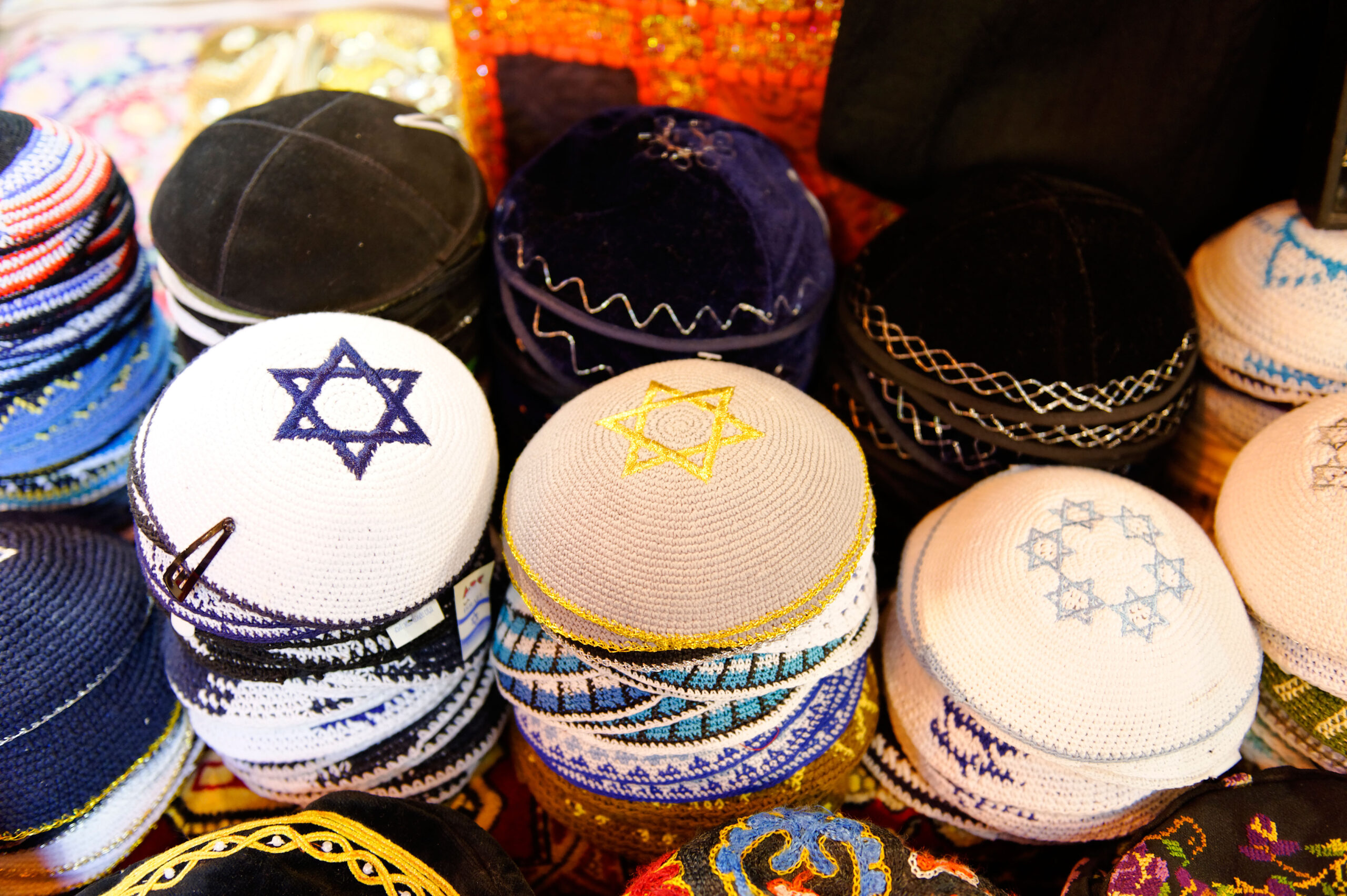 Stacks of colourful kippahs, some with Star of David designs.