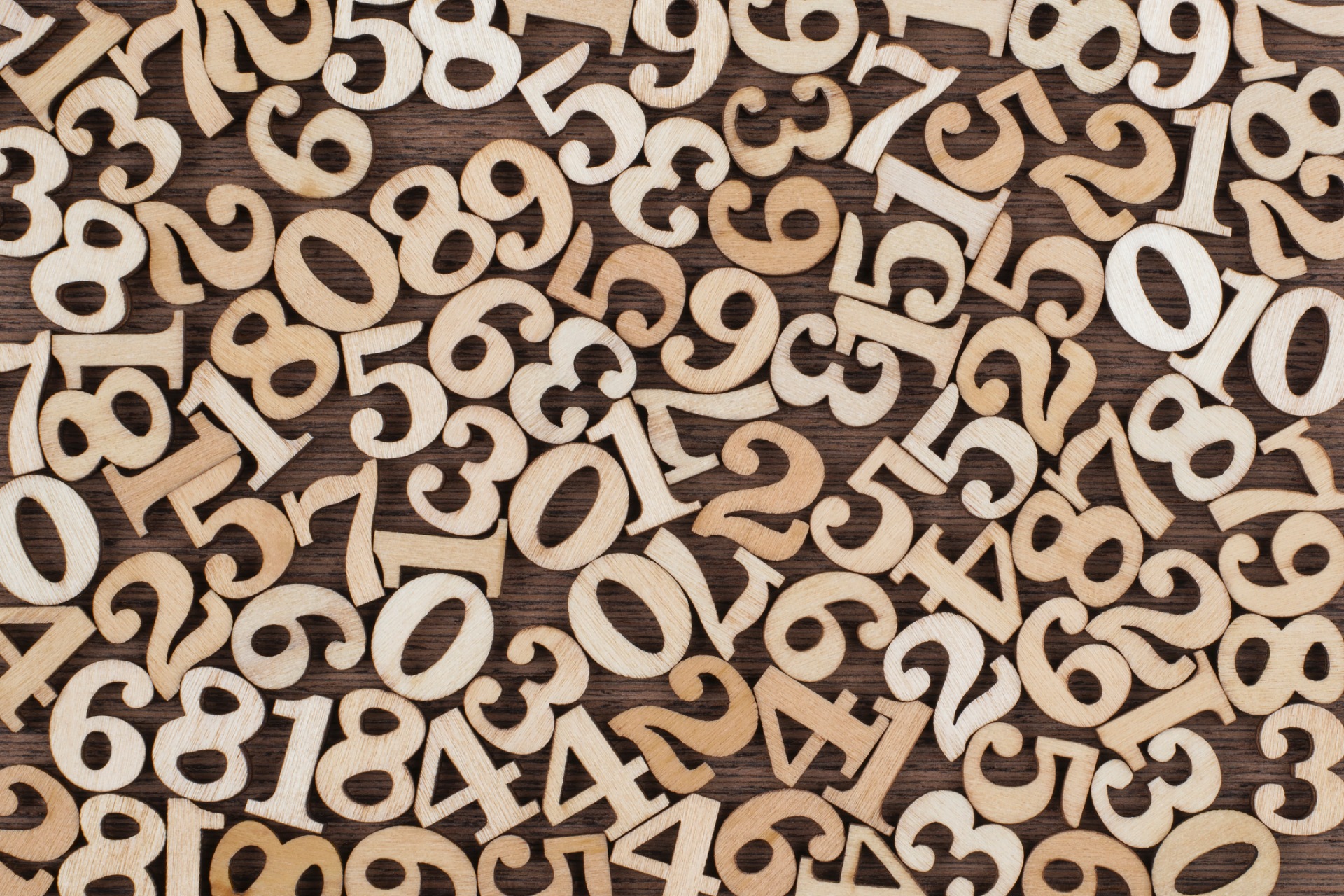 Wooden numbers scattered across a wooden surface.