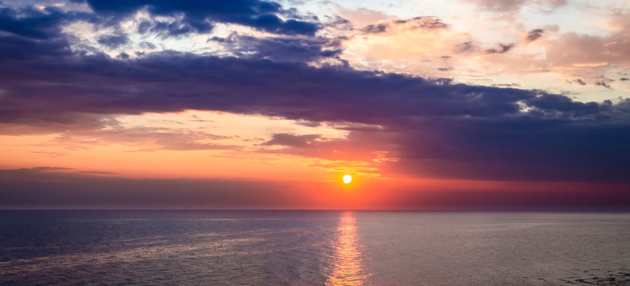Dusk sunset over calm ocean in summer