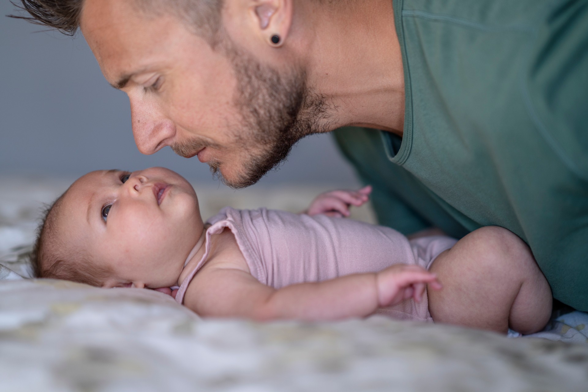 father whispering to baby