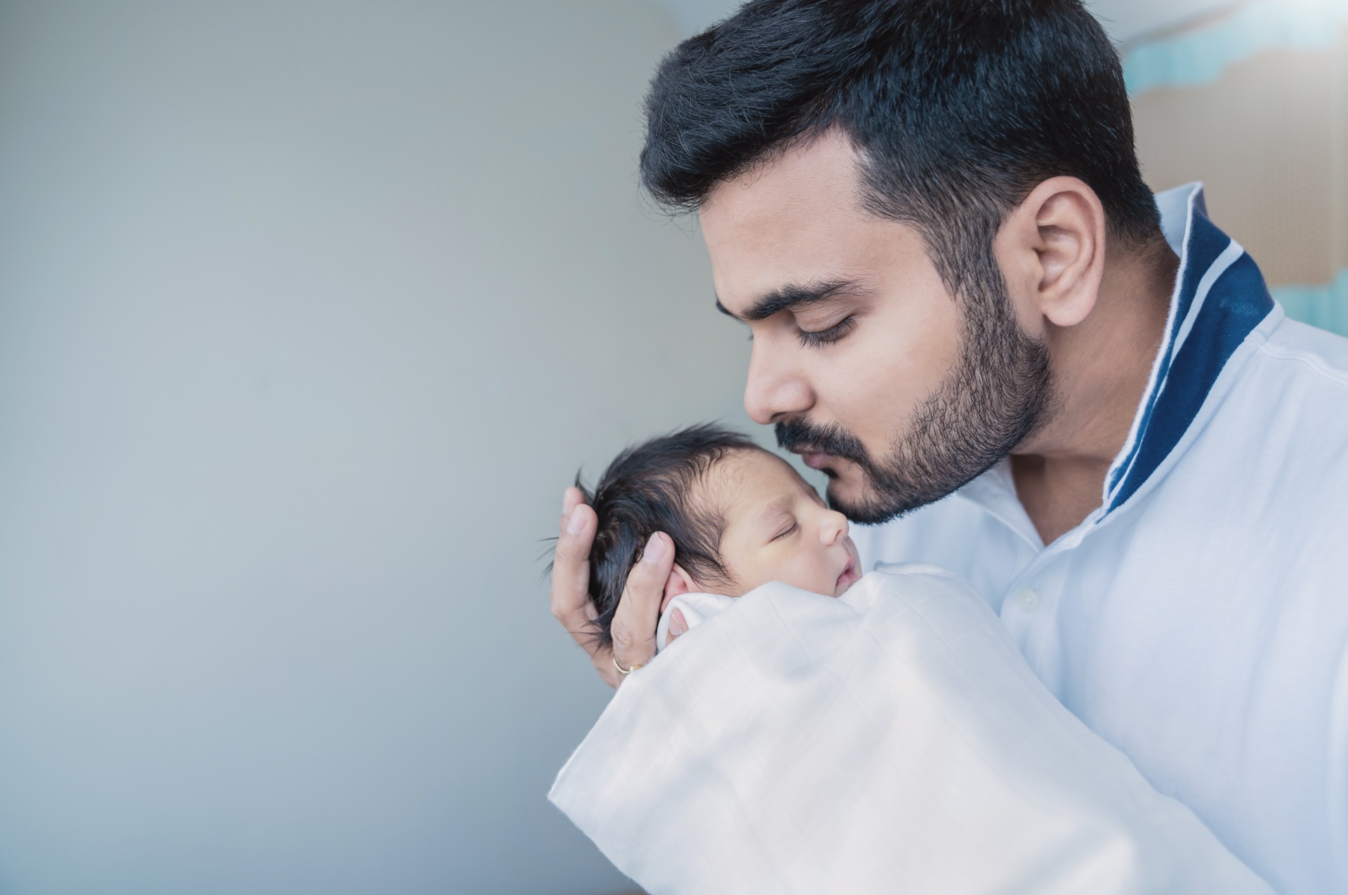 father whispering to baby