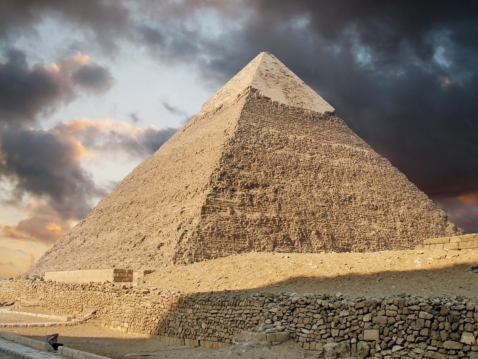 One of the Great Pyramids of Giza in Egypt, with a cloudy sky behind it