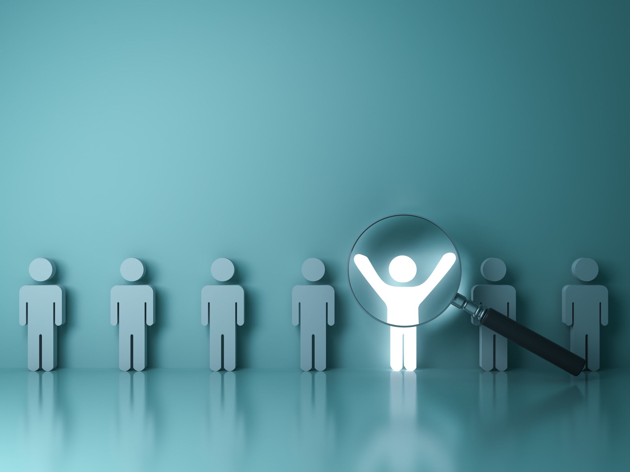 Magnifying glass highlighting a figure among several others, symbolising focus or search for uniqueness.