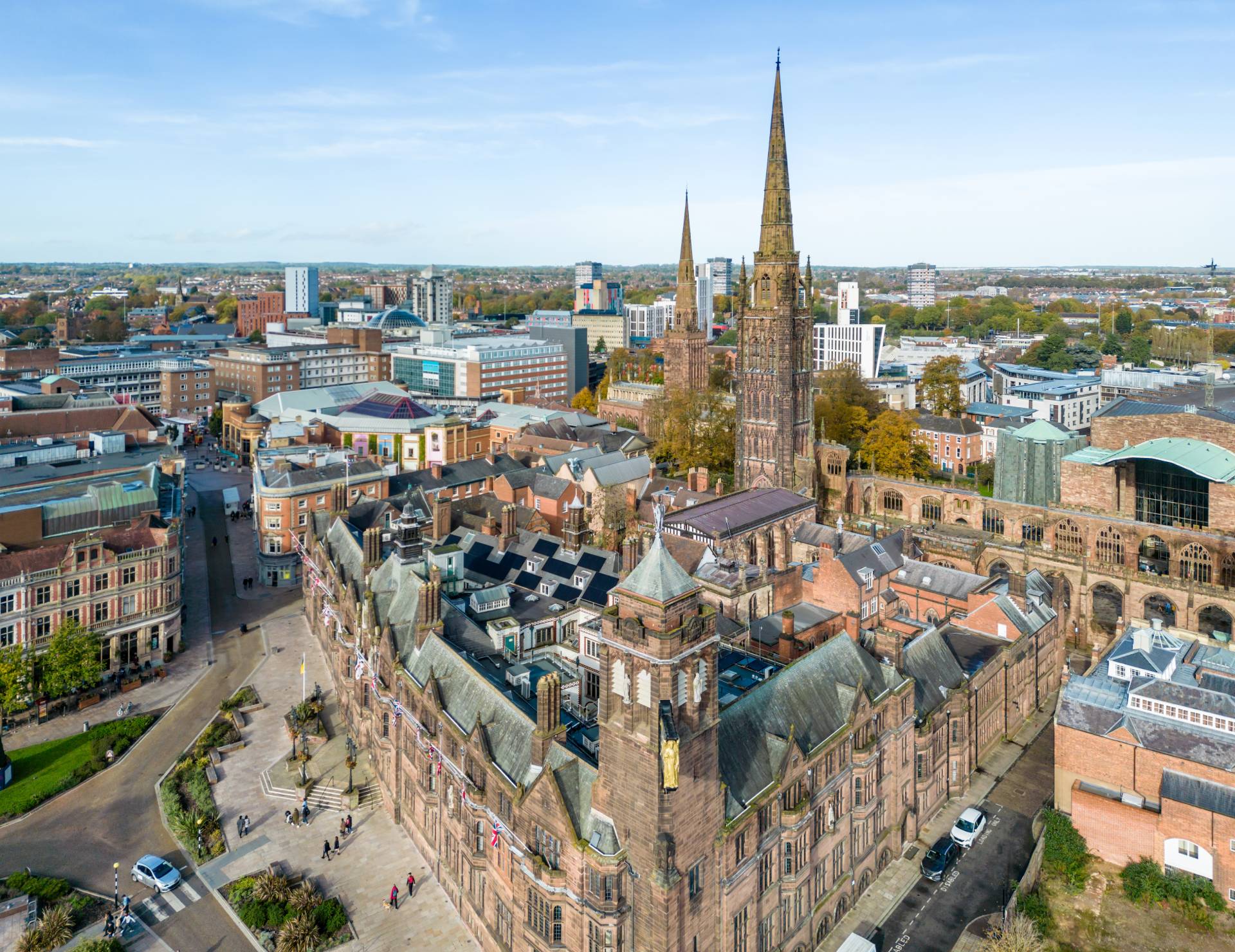 An aerial photo of Coventry city centre showing buildings, offices, churches and green spaces