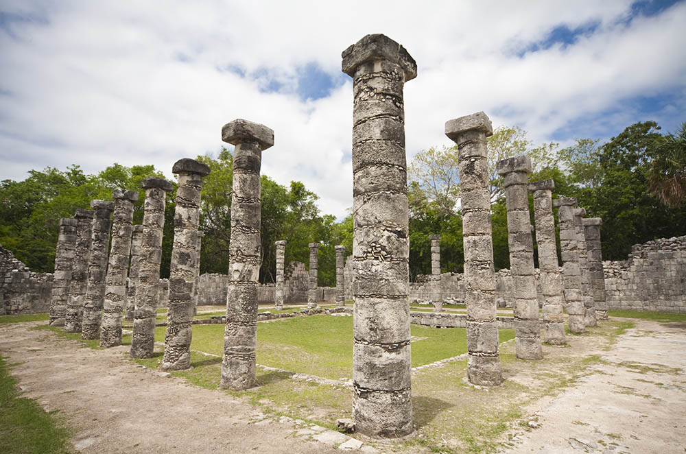 Tall stone columns standing in rows at an ancient ruin.