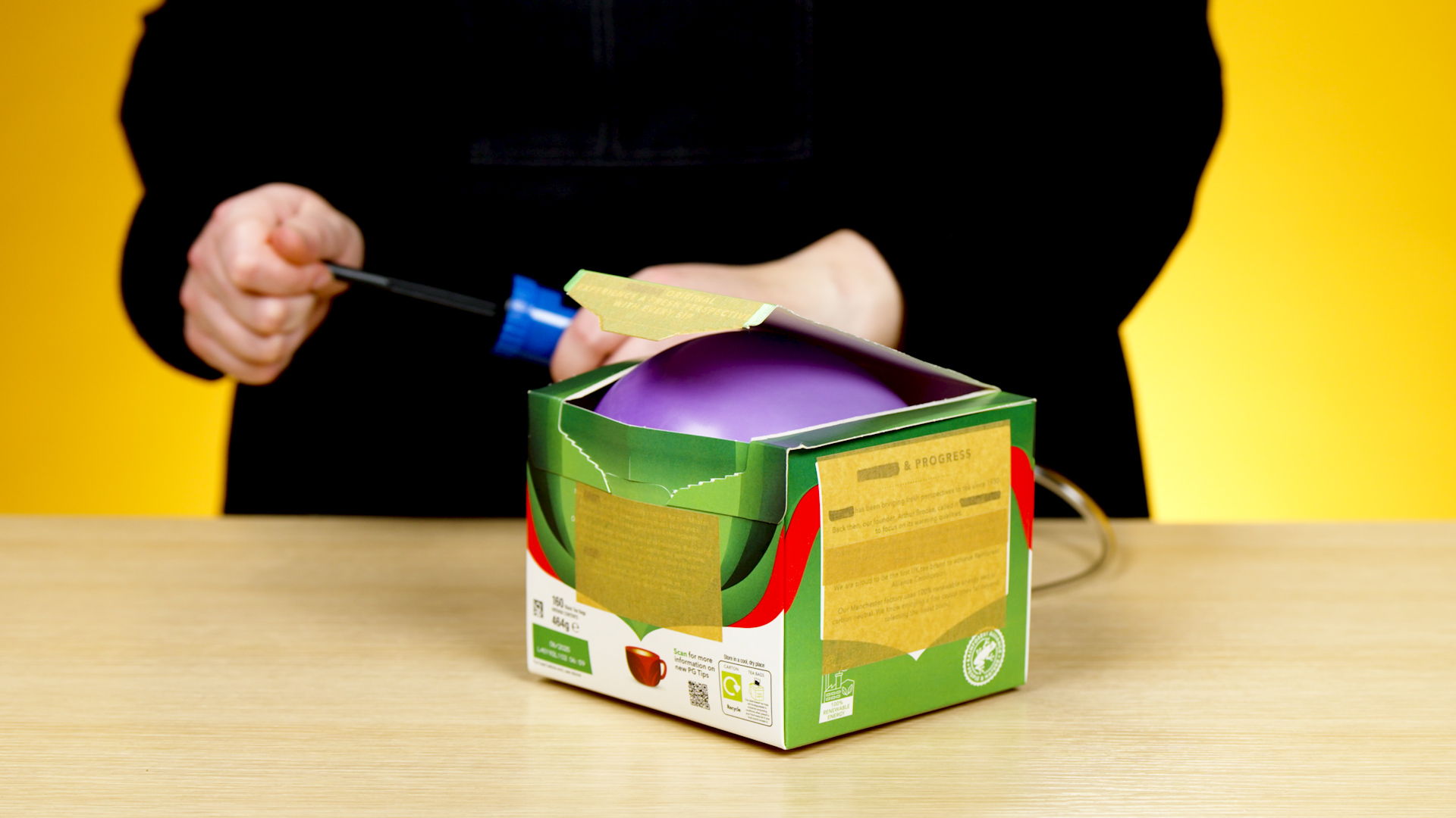 balloon inflating inside a lidded box