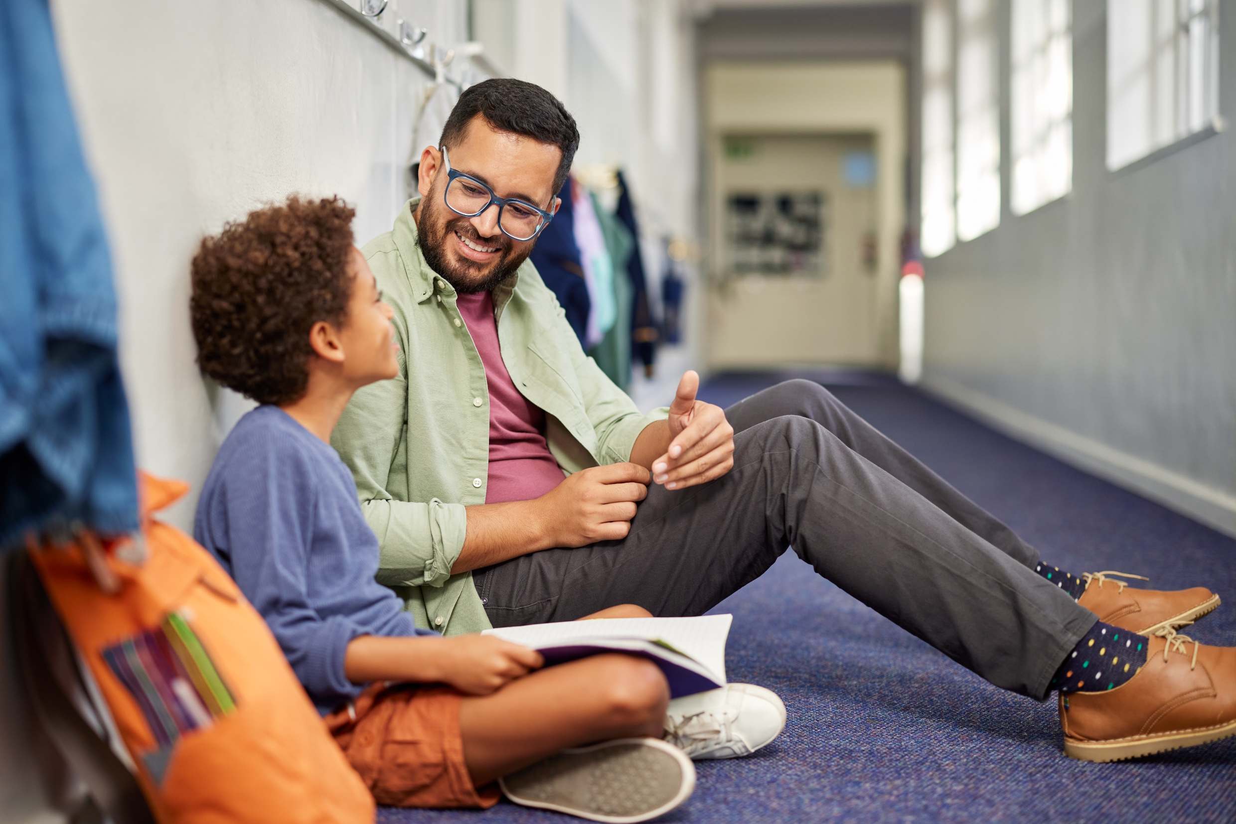 A teacher supporting a child outside the classroom.