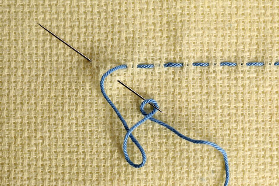 Single line of running stitch, with needle and thread.