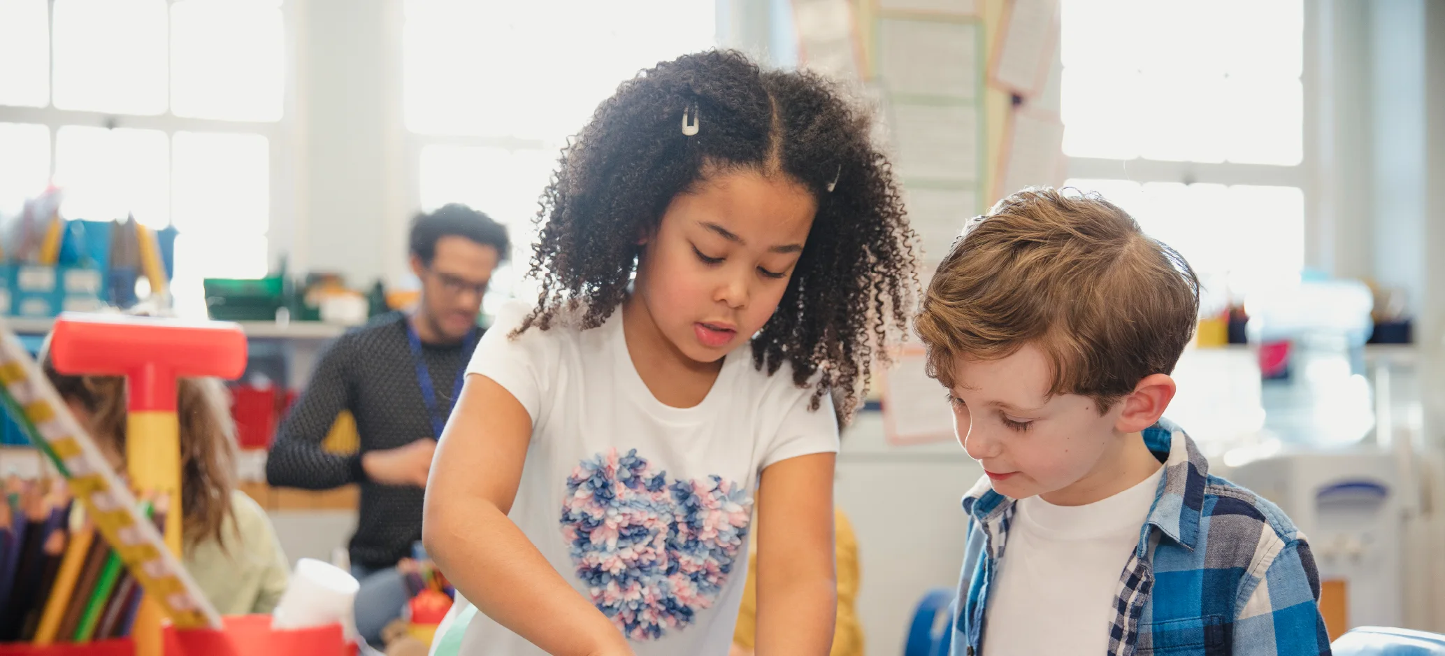 Two primary pupils collaborating on a classroom task together