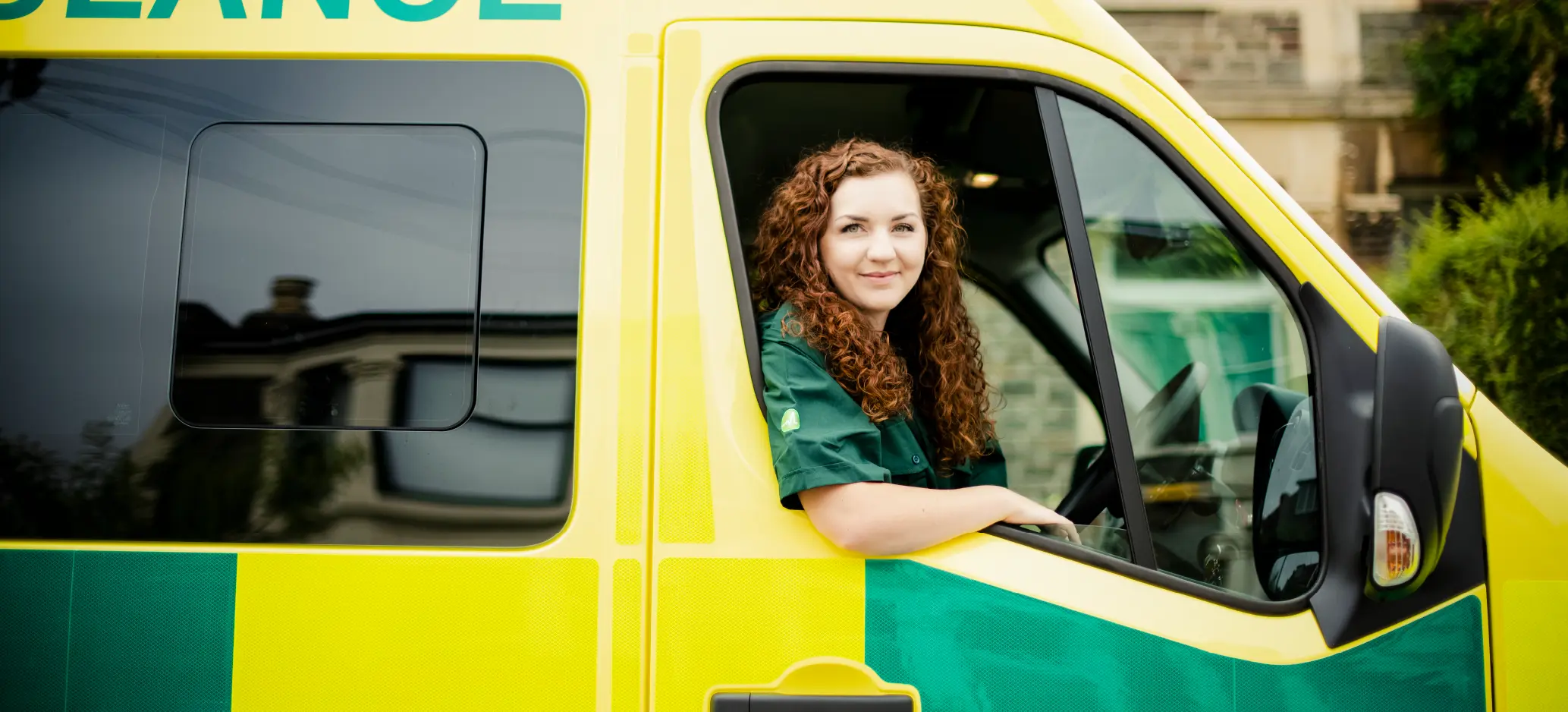 Paramedic sitting in an ambulance cab, ready to respond to an emergency call