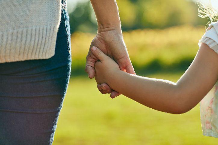 Child holding mother's hand