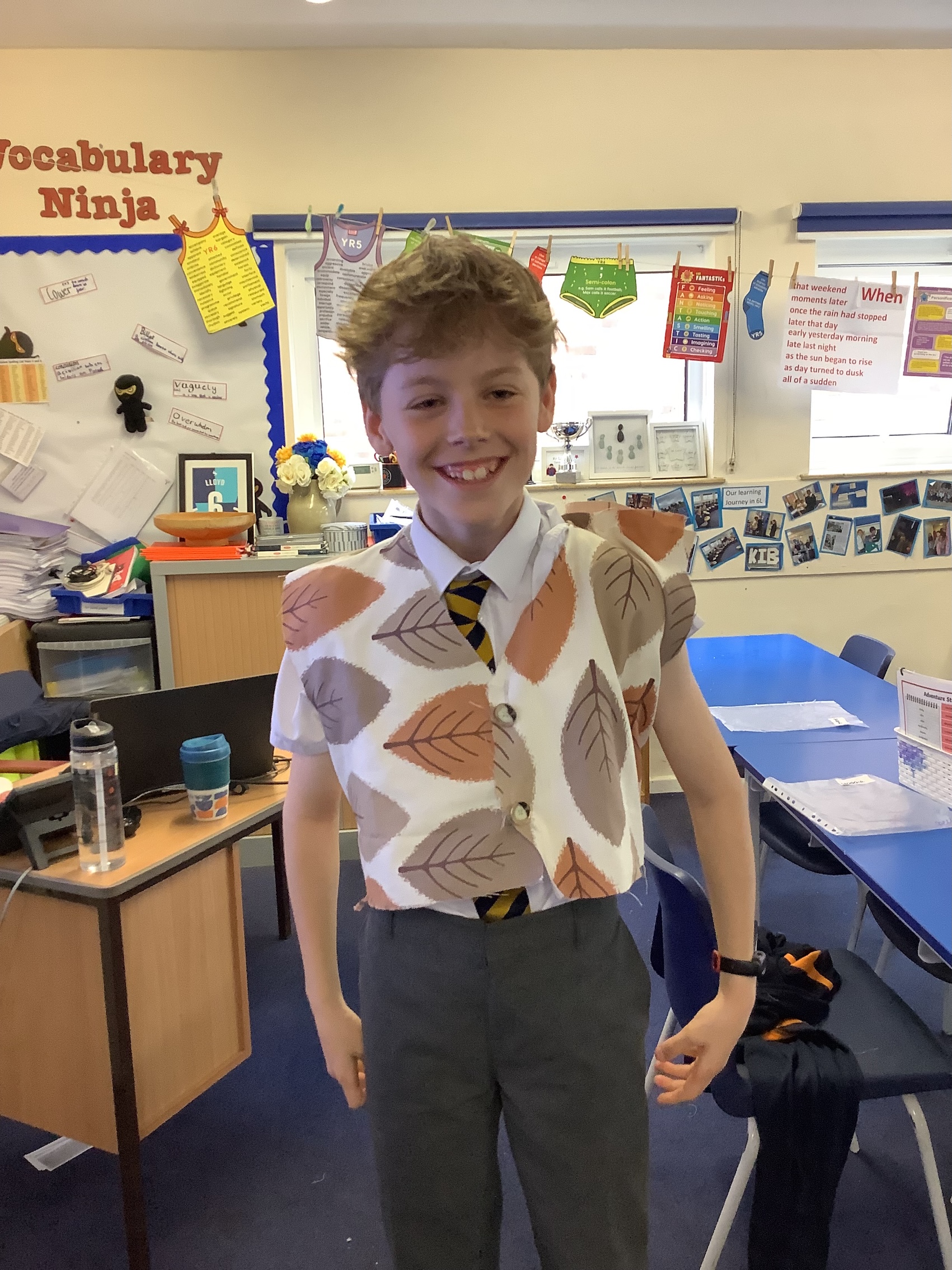 Yer 6 child wearing a hand-sewn waistcoat and smiling.