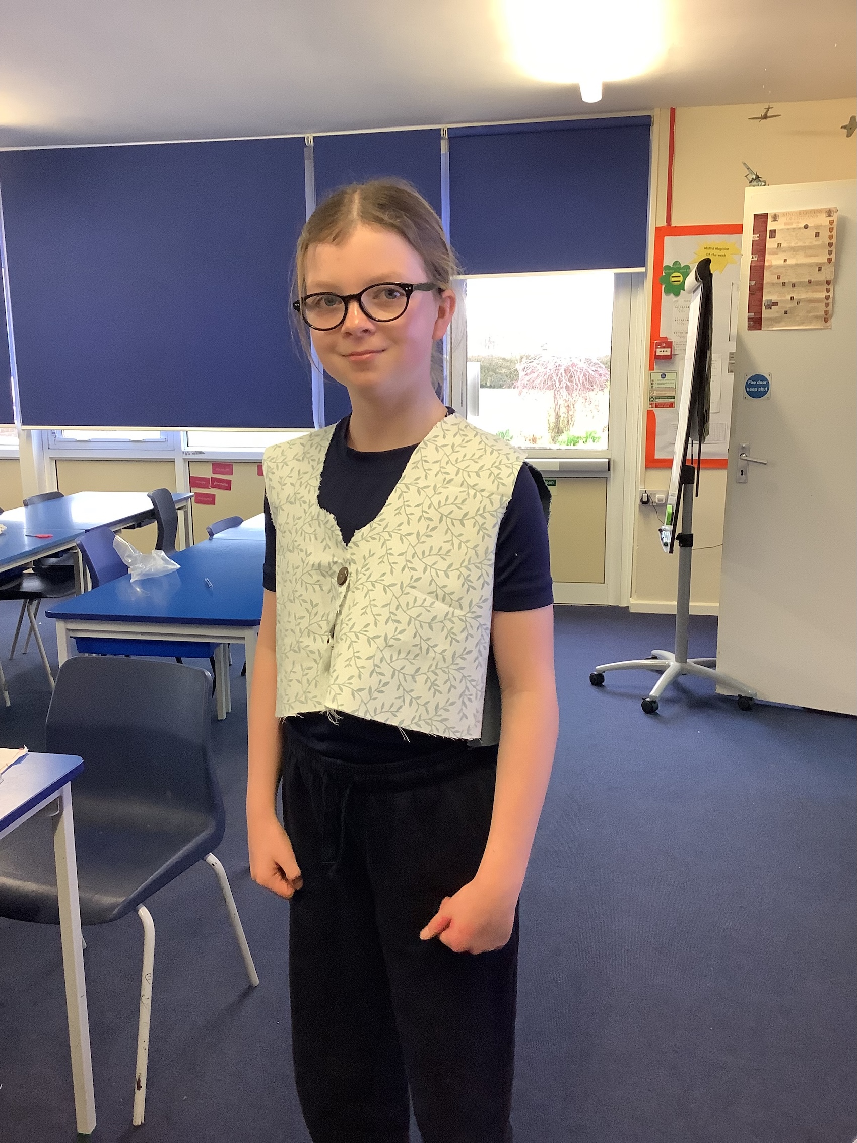 Year 6 child wearing a hand-sewn waistcoat.