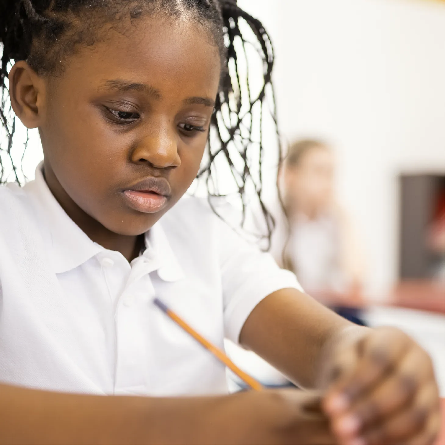 A young primary school pupil concentrating on her work.