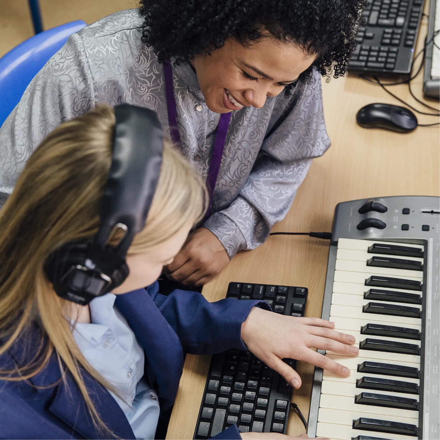A pupil plays a keyboard.
